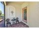 Charming front porch features brick floor and decorous black metal seating at 12640 Felice Dr, Venice, FL 34293