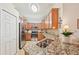Kitchen features stainless steel appliances, plenty of wood cabinets and granite countertops at 12640 Felice Dr, Venice, FL 34293