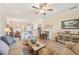 Spacious living area with tile flooring, and seamless flow to dining and kitchen at 12640 Felice Dr, Venice, FL 34293