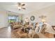 Inviting living room with neutral tones, tile flooring, and sliding doors to the lanai at 12640 Felice Dr, Venice, FL 34293