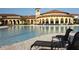 Expansive pool area with lounge chairs, umbrellas, and elegant architecture, perfect for relaxation at 12640 Felice Dr, Venice, FL 34293