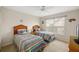 Cozy bedroom with twin beds, window and ceiling fan, offers a comfortable and inviting space at 128 Braemar Ave, Venice, FL 34293
