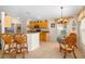 Eat-in kitchen featuring a breakfast bar, wooden cabinets and a dining area with decorative chandelier at 128 Braemar Ave, Venice, FL 34293