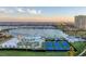Aerial view of recreational area with mini-golf, tennis courts, pool, marina, and waterfront views at 130 Riviera Dunes Way # 903, Palmetto, FL 34221