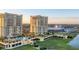 Beautiful aerial view of condo buildings, pool, and grounds with tropical trees at 130 Riviera Dunes Way # 903, Palmetto, FL 34221