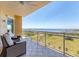 Relaxing balcony featuring comfortable seating and panoramic views of the serene waterfront and landscape at 130 Riviera Dunes Way # 903, Palmetto, FL 34221