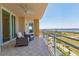 Relaxing balcony with comfortable seating, ceiling fan, and expansive water views at 130 Riviera Dunes Way # 903, Palmetto, FL 34221