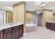Bathroom with double sink vanity, soaking tub, and walk-in glass shower at 130 Riviera Dunes Way # 903, Palmetto, FL 34221