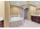 Bathroom with soaking tub, walk-in glass shower, and stylish fixtures at 130 Riviera Dunes Way # 903, Palmetto, FL 34221