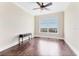 Bedroom with hardwood floors, ceiling fan, and water views at 130 Riviera Dunes Way # 903, Palmetto, FL 34221