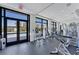 Well-equipped gym features weight machines, free weights, and a glass door leading to the outdoor pool at 130 Riviera Dunes Way # 903, Palmetto, FL 34221