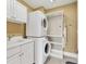 Efficient laundry room with stacked washer and dryer units and built-in sink at 130 Riviera Dunes Way # 903, Palmetto, FL 34221