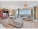 Bright living room boasting tiled floors, comfortable seating, and large windows with picturesque water views at 130 Riviera Dunes Way # 903, Palmetto, FL 34221