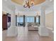 Spacious living room featuring tiled floors, expansive windows with water views, and stylish columns at 130 Riviera Dunes Way # 903, Palmetto, FL 34221