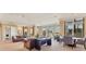 Comfortable lounge area with seating, tables, and large windows at 130 Riviera Dunes Way # 903, Palmetto, FL 34221