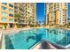 Lovely swimming pool next to buildings with balconies, creating a resort-style living experience at 130 Riviera Dunes Way # 903, Palmetto, FL 34221