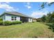 A large backyard with green lawn and a spacious screened-in patio at 13319 Deep Blue Pl, Bradenton, FL 34211