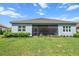 A well-maintained backyard featuring lush green grass and a screened-in patio at 13319 Deep Blue Pl, Bradenton, FL 34211