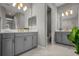 Bright bathroom with dual vanities, marble floors, modern lighting, and updated fixtures at 13319 Deep Blue Pl, Bradenton, FL 34211