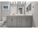 Bathroom featuring double sink vanity, grey cabinets with gold hardware, and marble floors at 13319 Deep Blue Pl, Bradenton, FL 34211