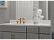 Close up of dual sink bathroom vanity featuring gold hardware, marble countertop, and decorative bust at 13319 Deep Blue Pl, Bradenton, FL 34211