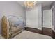 Bedroom featuring a luxurious crib, hardwood floors, and abundant natural light at 13319 Deep Blue Pl, Bradenton, FL 34211