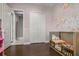 Bedroom featuring crib with floral wall decor and access to the ensuite bathroom at 13319 Deep Blue Pl, Bradenton, FL 34211