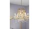Elegant chandelier featuring intricate detailing and sparkling crystals illuminating the room at 13319 Deep Blue Pl, Bradenton, FL 34211