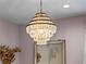 Elegant tiered crystal chandelier with gold trim provides ambient lighting and adds a luxurious touch at 13319 Deep Blue Pl, Bradenton, FL 34211
