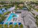 A luxury community pool with shade cabanas, seating, lush lawns, and a beautiful lake at 13319 Deep Blue Pl, Bradenton, FL 34211