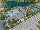 A bird's eye view shows a luxurious community pool, cabanas, and tennis courts at 13319 Deep Blue Pl, Bradenton, FL 34211