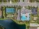 Aerial view shows a swimming pool, tennis courts, a playground, and manicured lawns at 13319 Deep Blue Pl, Bradenton, FL 34211
