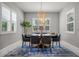 Bright dining room featuring modern light fixture, plantation shutters, and an elegant round table at 13319 Deep Blue Pl, Bradenton, FL 34211