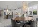 Spacious dining area seamlessly connects to a modern kitchen with white cabinets at 13319 Deep Blue Pl, Bradenton, FL 34211
