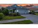 Charming one-story home featuring a manicured lawn, beautiful landscaping, and an attached two-car garage at 13319 Deep Blue Pl, Bradenton, FL 34211