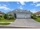 Beautiful one-story home with an attached two-car garage, a tile roof, and well-manicured landscaping at 13319 Deep Blue Pl, Bradenton, FL 34211