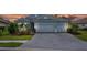 Beautiful one-story home featuring a well-manicured lawn, landscaping, and a two-car garage at 13319 Deep Blue Pl, Bradenton, FL 34211