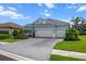 Charming one-story home featuring a manicured lawn, landscaping, and a two-car garage at 13319 Deep Blue Pl, Bradenton, FL 34211