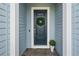 Elegant front door with a green wreath and complementing plant at 13319 Deep Blue Pl, Bradenton, FL 34211