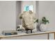 Intriguing hallway decor featuring statuary art with decor books in modern design at 13319 Deep Blue Pl, Bradenton, FL 34211