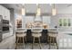 Modern kitchen featuring an island with bar seating, sleek countertops, and stainless steel appliances at 13319 Deep Blue Pl, Bradenton, FL 34211
