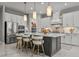 Stylish kitchen with stainless steel appliances, a large island with bar seating, and modern pendant lighting at 13319 Deep Blue Pl, Bradenton, FL 34211