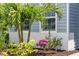 Lush landscaping with palm trees and flowering plants surrounding the home at 13319 Deep Blue Pl, Bradenton, FL 34211