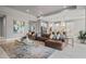 Open-concept living room with sleek marble floors, bright lighting, and decorative artwork and decor at 13319 Deep Blue Pl, Bradenton, FL 34211