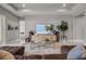 Bright and airy living room with a large television, stylish speakers, comfortable seating, and luxury decor at 13319 Deep Blue Pl, Bradenton, FL 34211