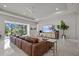 Spacious living room with a large sectional, stylish decor, and bright natural light from the sliding glass doors at 13319 Deep Blue Pl, Bradenton, FL 34211