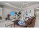 Bright living room featuring modern decor, comfortable seating, and an open-concept design with marble floors at 13319 Deep Blue Pl, Bradenton, FL 34211