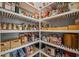 Walk-in pantry with organized shelving, showcasing a variety of food items and kitchen essentials at 13319 Deep Blue Pl, Bradenton, FL 34211