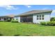 Home's backyard with healthy grass and a screened lanai for relaxing and entertaining at 13319 Deep Blue Pl, Bradenton, FL 34211