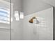 Close up of shower featuring white tile and a gold shower head fixture at 13319 Deep Blue Pl, Bradenton, FL 34211